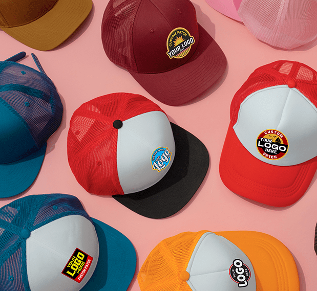 Assorted custom hats with different colors and logo patches displayed on a pink background.