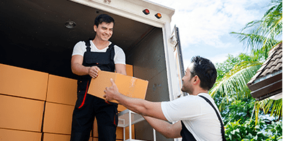 Two workers unloading boxes from a delivery truck.
