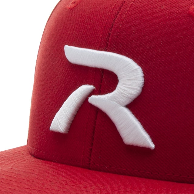 Detail of a red cap with a large white embroidered "R" on the front panel