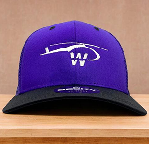 Purple and black cap with helicopter silhouette and 'WW' logo, on a wooden backdrop.