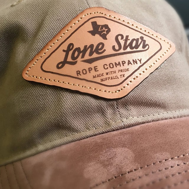 Close-up of a Lone Star Rope Company leather patch on a cap, crafted in Buffalo, TX