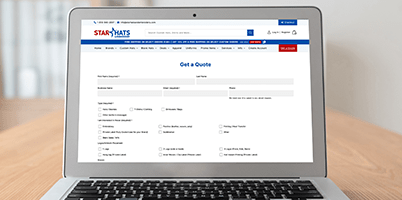 Laptop screen displaying 'Get a Quote' form on Star Hats website.