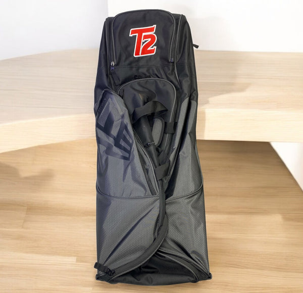 Large black travel sports equipment bag with T2 red logo on wooden floor