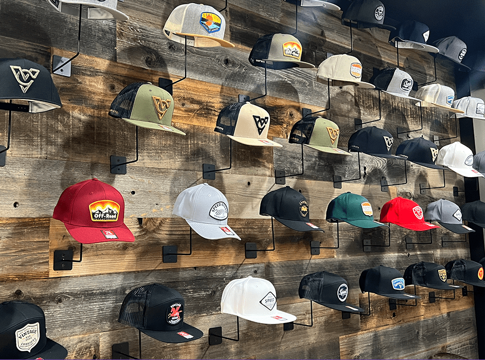 Various varieties of multicoloured hats hanging on a wall