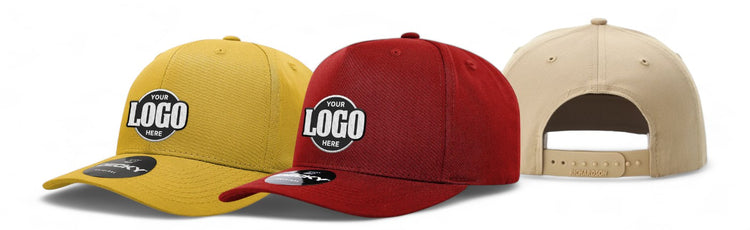 Three baseball caps in mustard, red, and beige, each featuring a customizable logo patch on the front