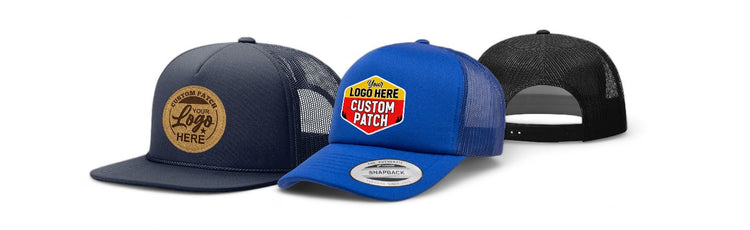 Two foam trucker hats in navy blue and bright blue with custom logo patches and mesh back panels, shown from side and rear