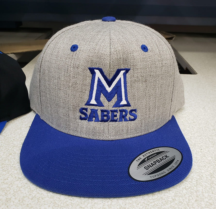 Grey and blue snapback hat with 'M Sabers' logo.