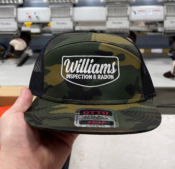 Camo trucker hat with Williams Inspection & Radon logo.