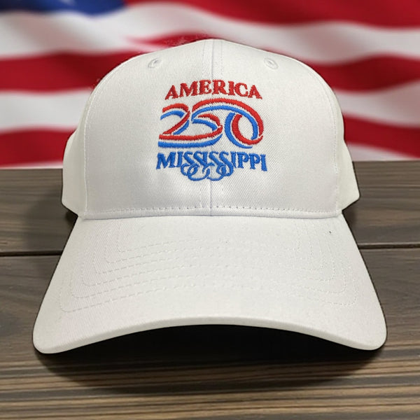 White embroidered hat featuring America 250 Mississippi logo in red and blue with U.S. flag background.