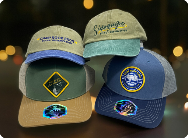 Assorted custom hats with embroidered logos, perfect for branding, events, and organizations, displayed in a stylish setting.