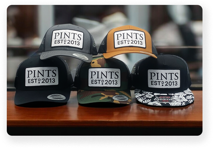 Collection of custom trucker hats with, Pints EST 2013 logo, featuring various colors and patterns, ideal for branding or casual wear.