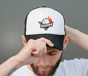 A man is wearing a black and white dad trucker hat with the Champs logo on it.