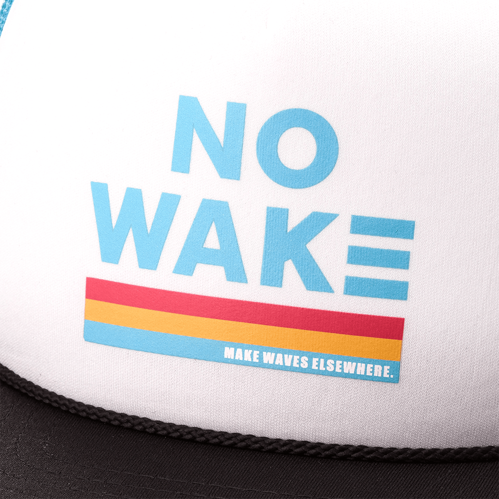 White cap with "NO WAKE" in blue letters, "MAKE WAVES ELSEWHERE" slogan beneath