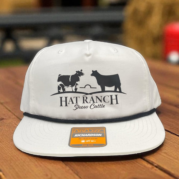White Richardson hat with Hat Ranch Show Cattle logo showing two cows in black silhouette design.