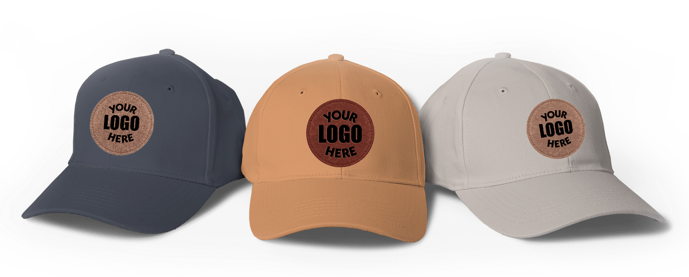 The image displays three caps in different colors: navy blue, tan, and beige. Each cap features a round leather patch on the front, showcasing the text 'YOUR LOGO HERE.'