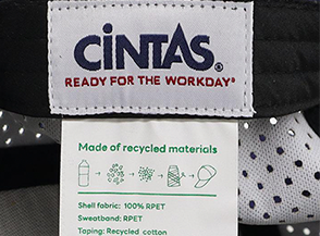 Cintas label on fabric, 'Ready for the Workday' slogan, with a tag showing the item is made from 100% recycled materials