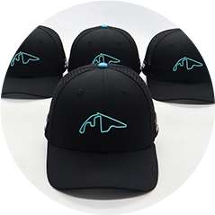 Four black baseball caps with cyan logo, front one focused against a white background.