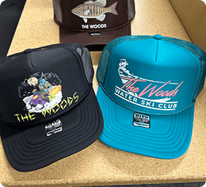 Assorted caps, including one with - The Woods Water Ski Club - on a turquoise cap