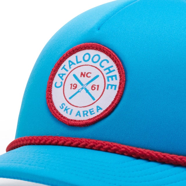 Bright blue cap with "CATALOOCHEE SKI AREA NC 1961" circle patch in red and white